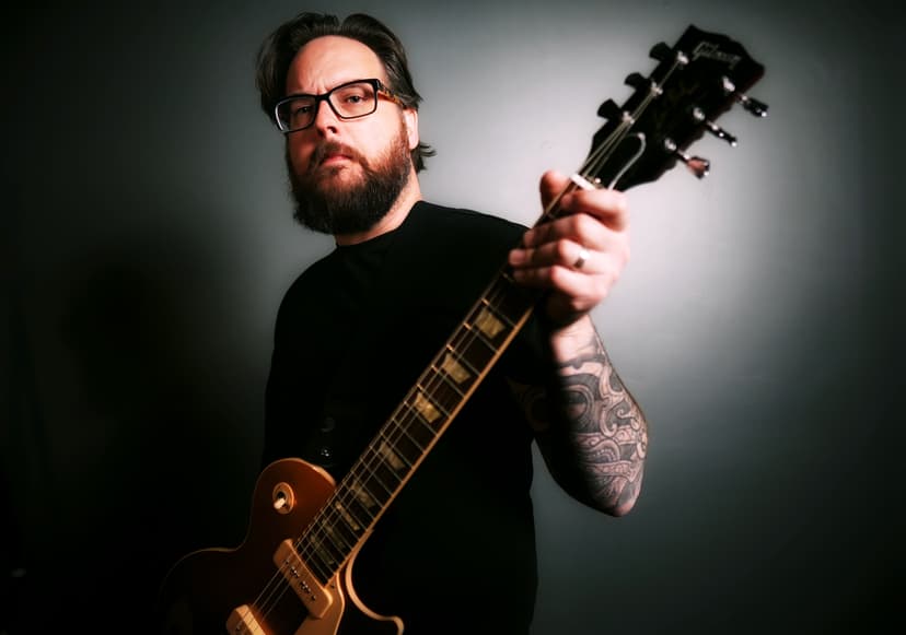 Sean Anthony Sullivan holds Gibson Goldtop Les Paul guitar.