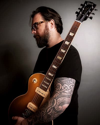 Sean Anthony Sullivan holds Gibson Goldtop Les Paul guitar.