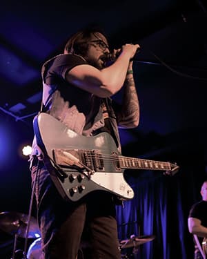 Sean Anthony Sullivan holds Gibson Goldtop Les Paul guitar.